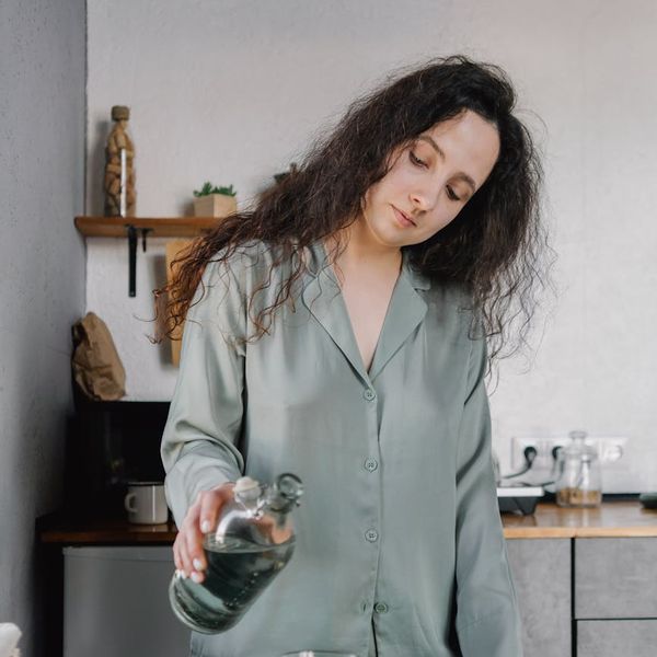 Woman smiling peacefully after a yoga session, feeling refreshed and energetic.